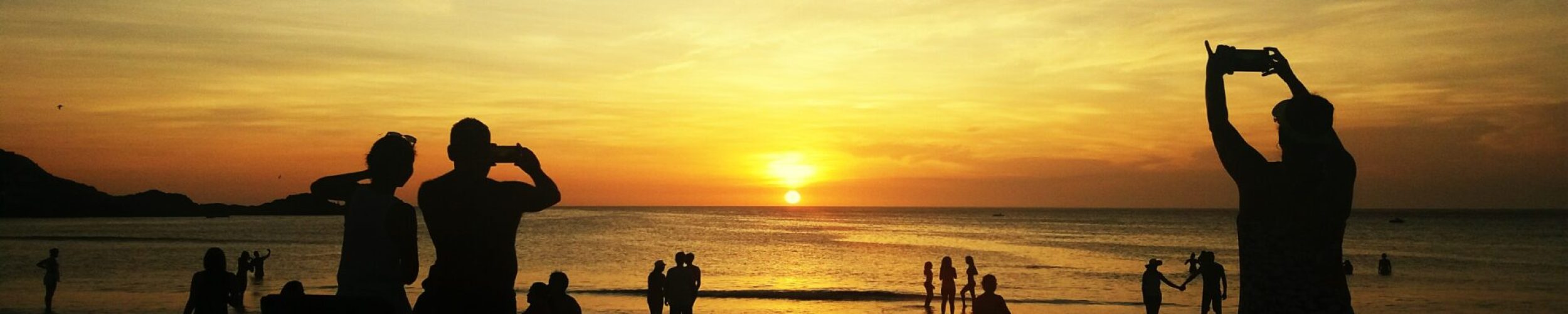 silhouette-people-beach-against-sky-sunset